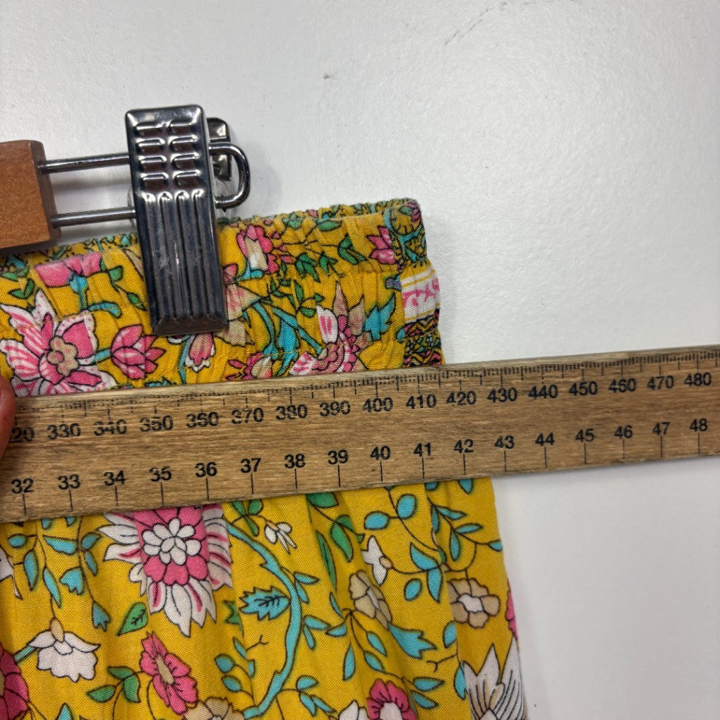 Yellow floral fabric with measuring tape detail view
