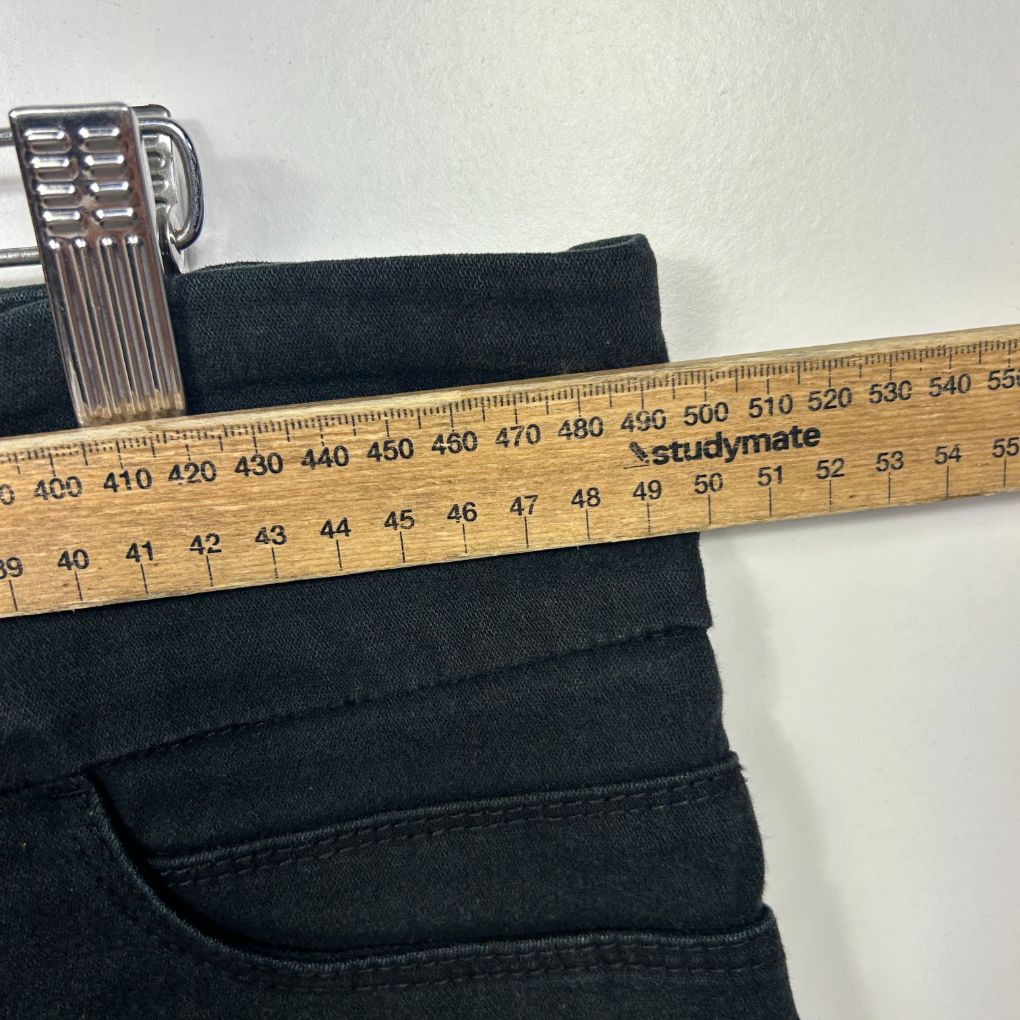 Black pants waistband measured with ruler detail view