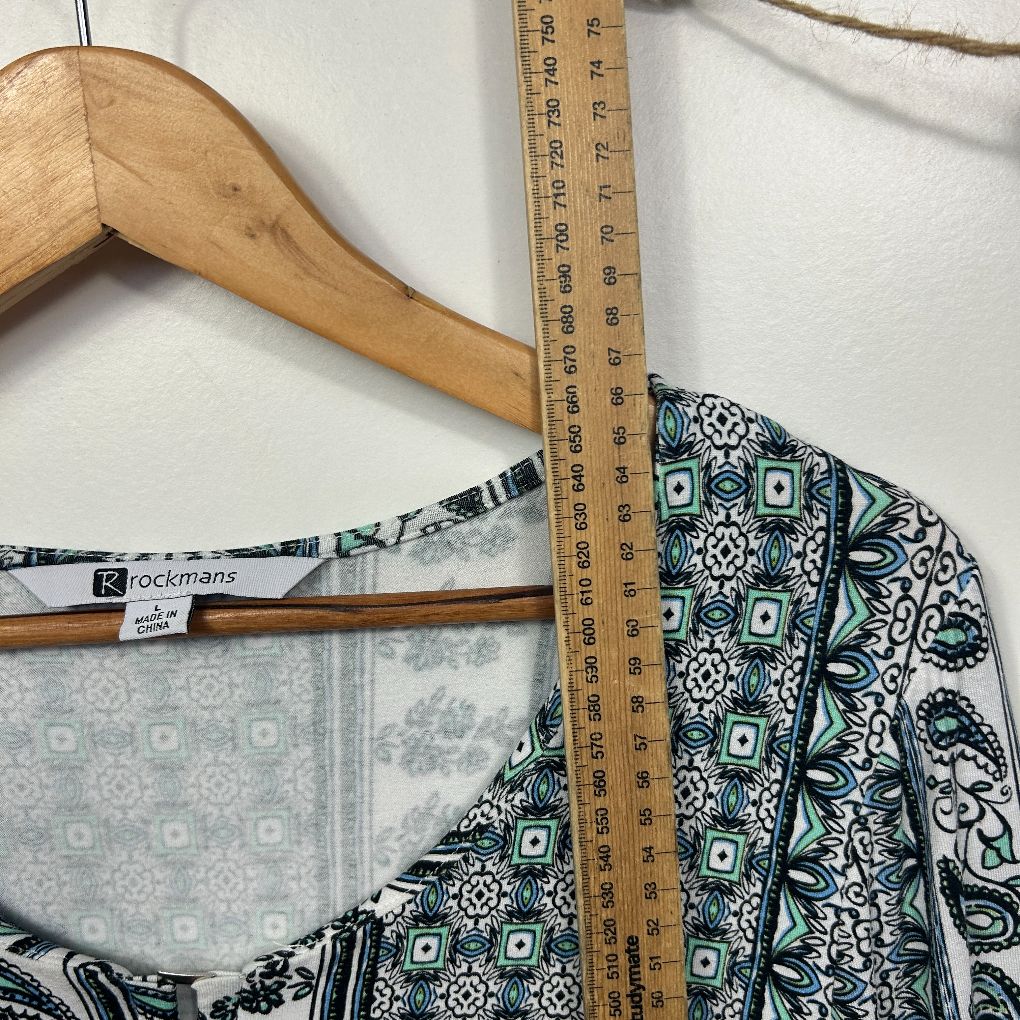 Black and white patterned top detail view on wooden hanger with measuring tape