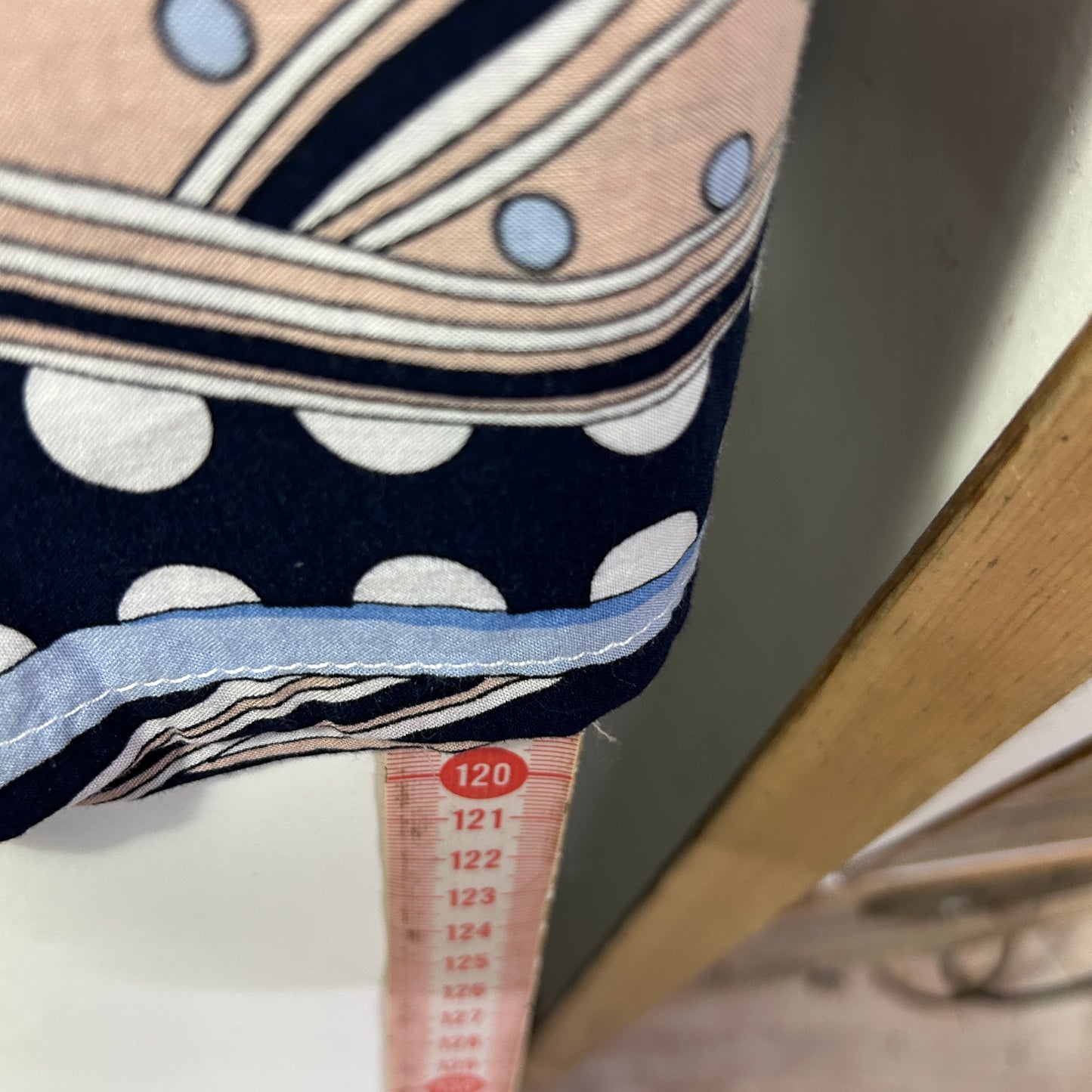 Navy and white polka dot fabric with striped trim detail view