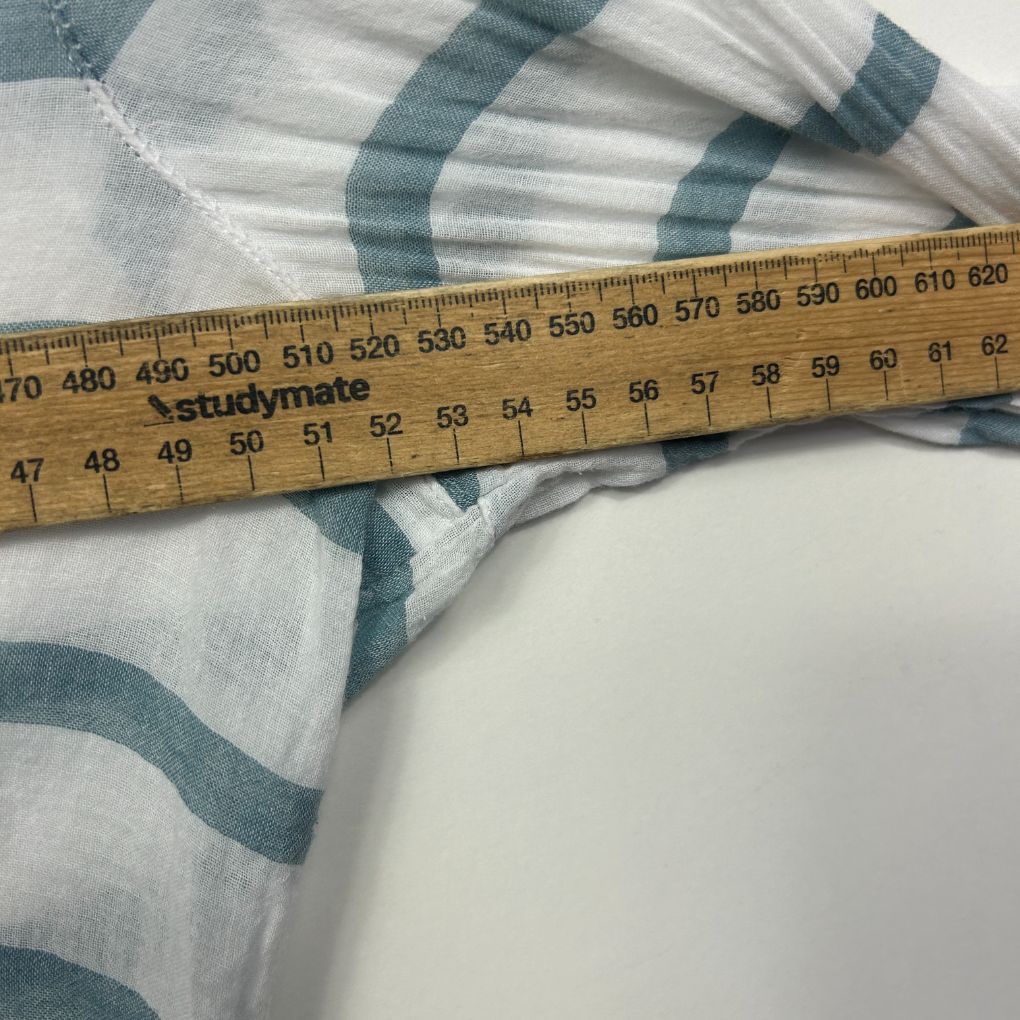 White and grey striped fabric detail view with measuring tape