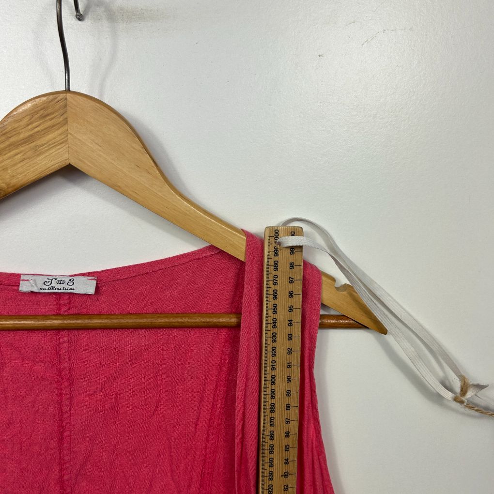 Pink top detail view with measurement tape