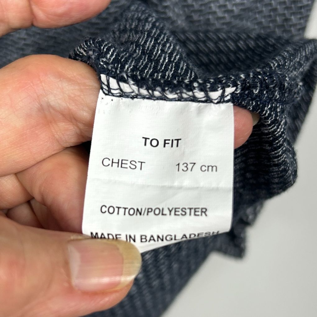 Black sweater label detail showing chest size 137cm