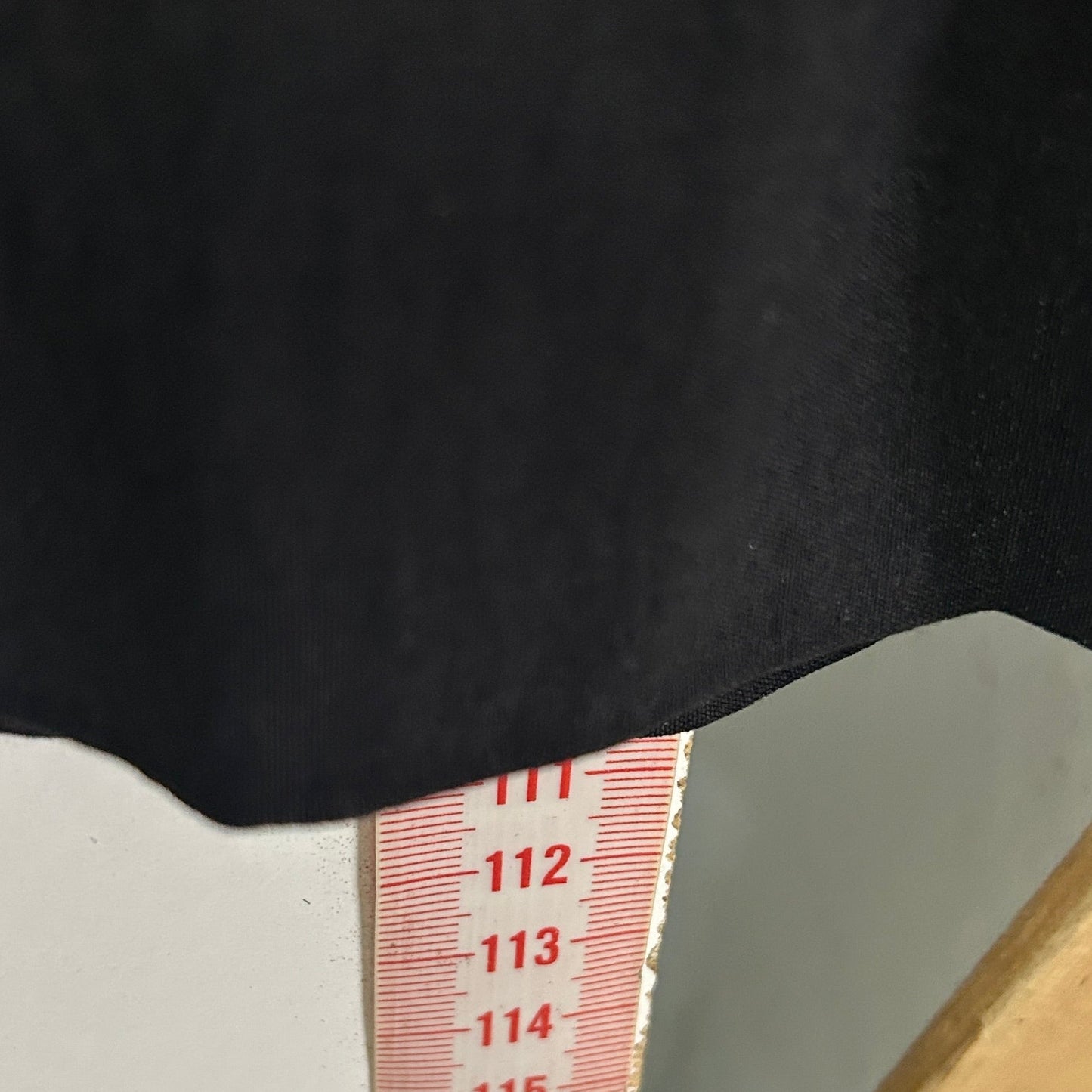 Black top with white cuff detail view