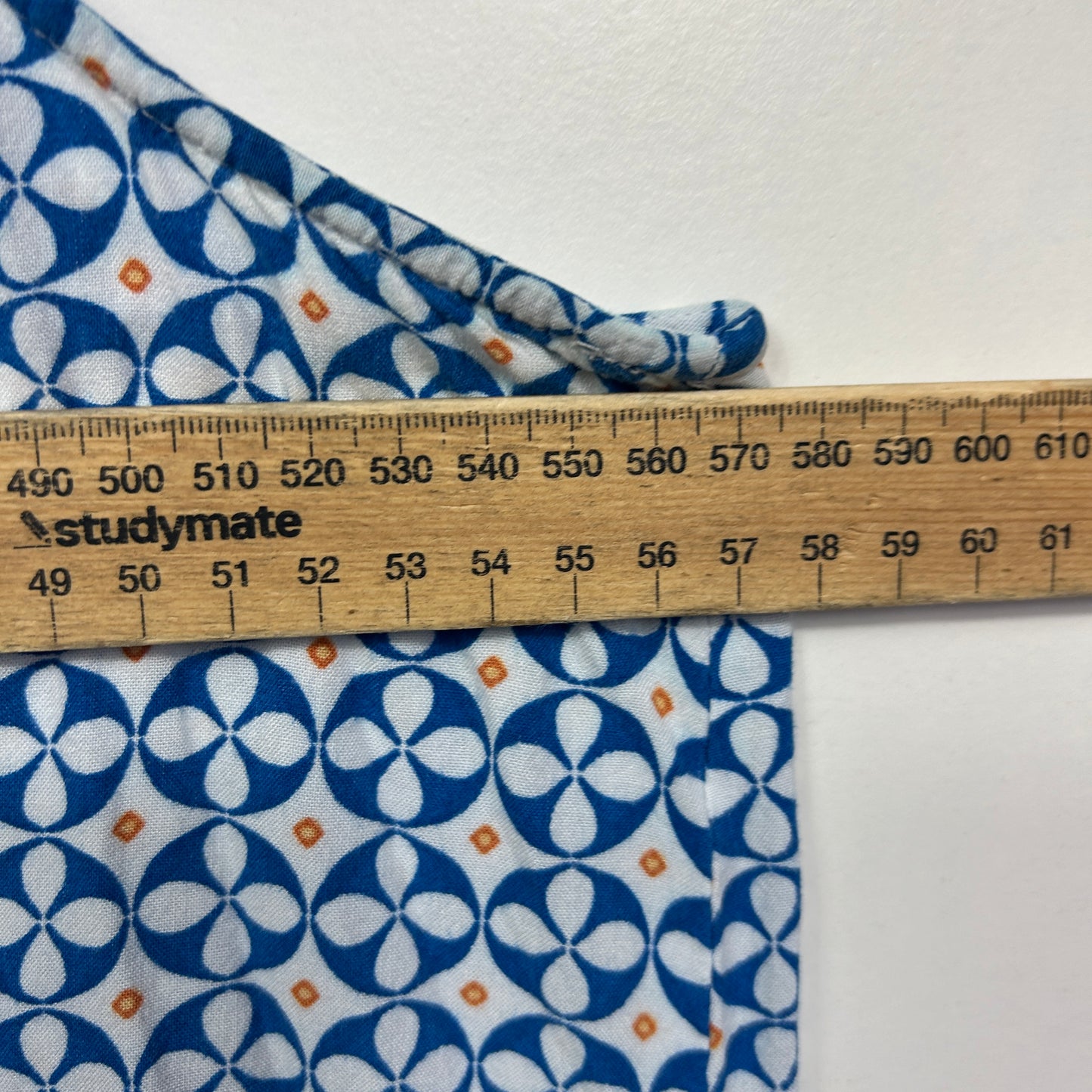 Blue and white floral fabric with measuring ruler detail view
