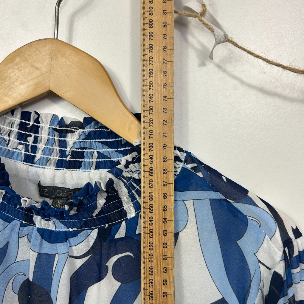 Blue and white graphic print top detail view on wooden hanger