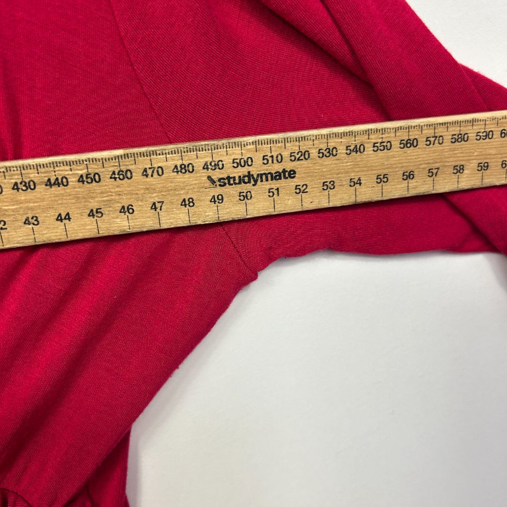Red fabric with measuring tape detail view