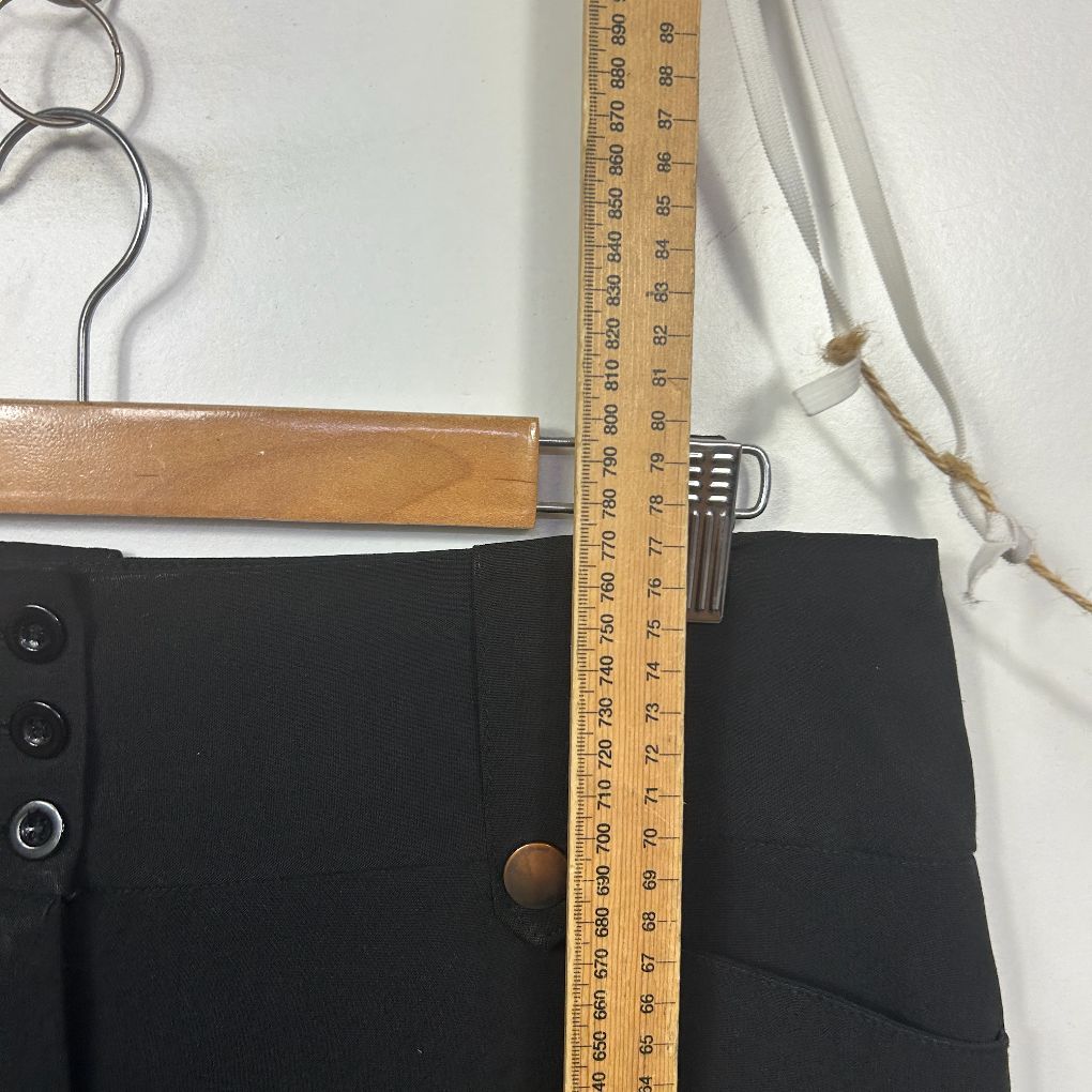 Black pants front view with measuring scale