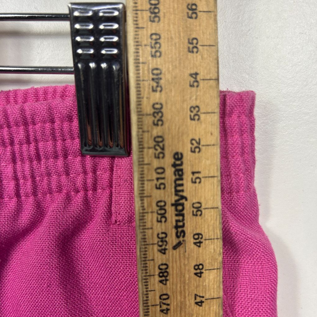Pink fabric waistband detail view with measuring ruler
