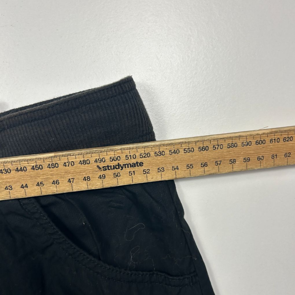 Navy blue ribbed knit pants detail view with measuring tape