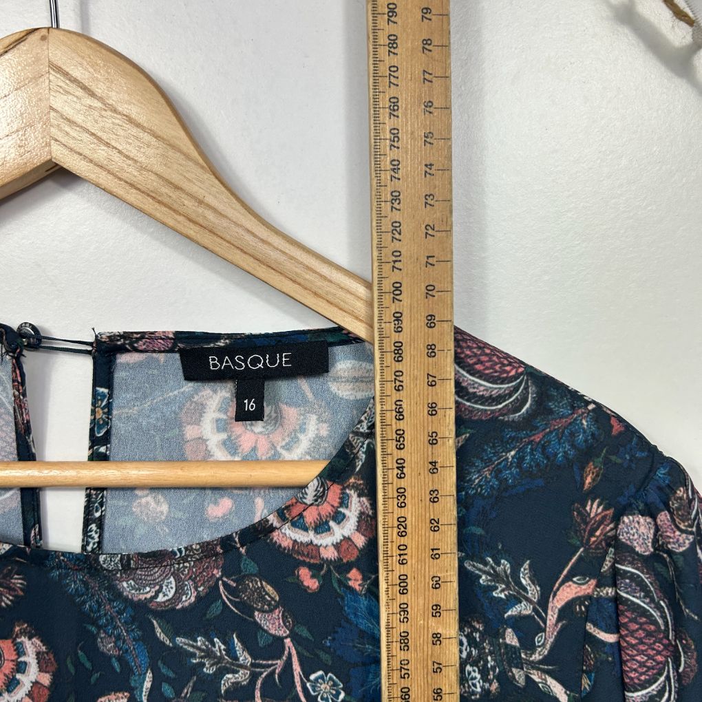 Navy floral top detail view with measuring tape