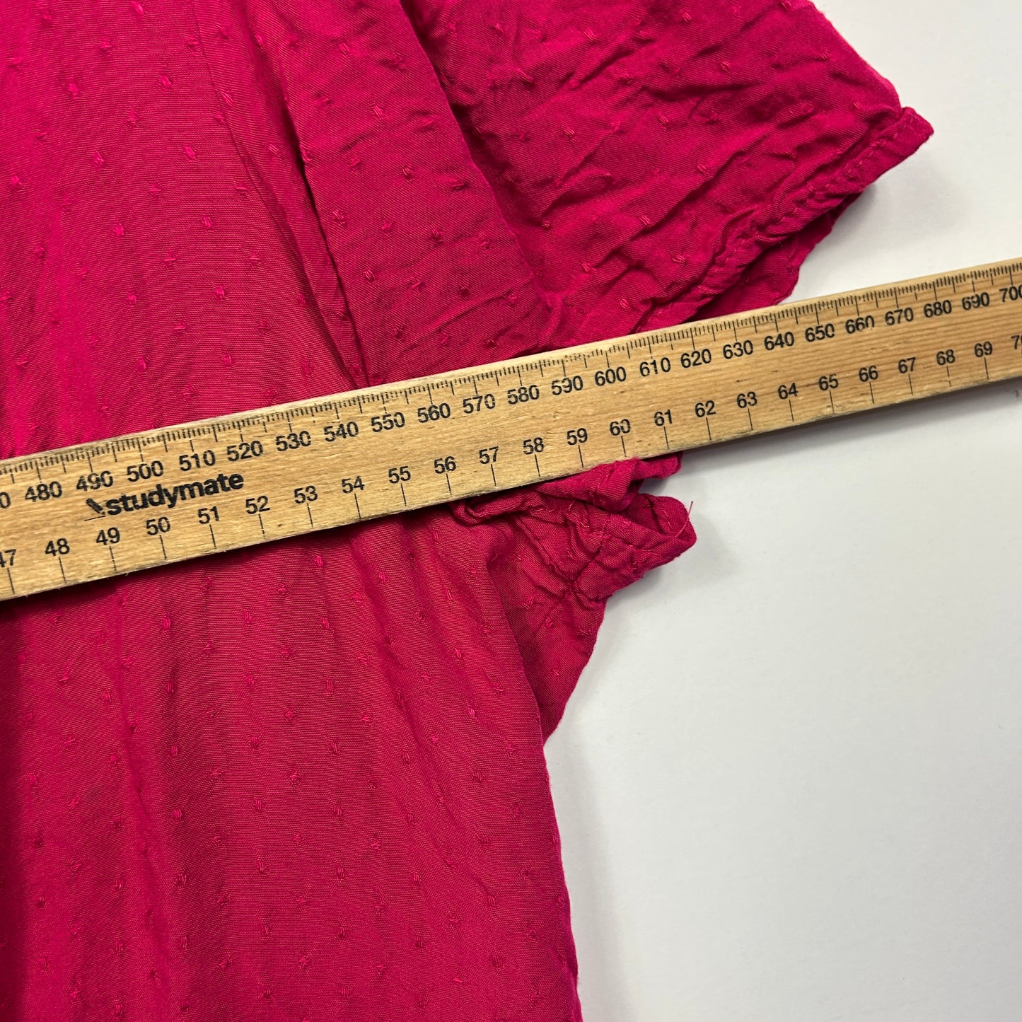 Pink dress with measuring tape detail view