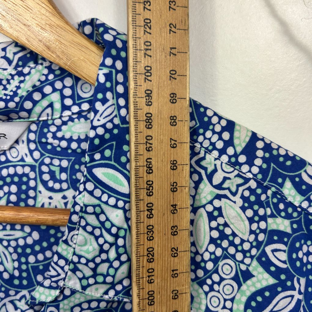 Blue and white patterned fabric detail view with wooden ruler