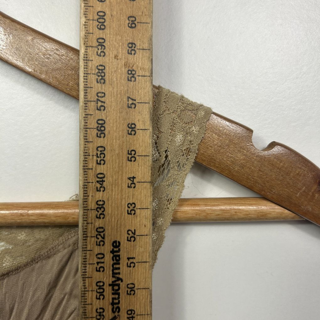 Measurement detail of garment showing ruler against fabric