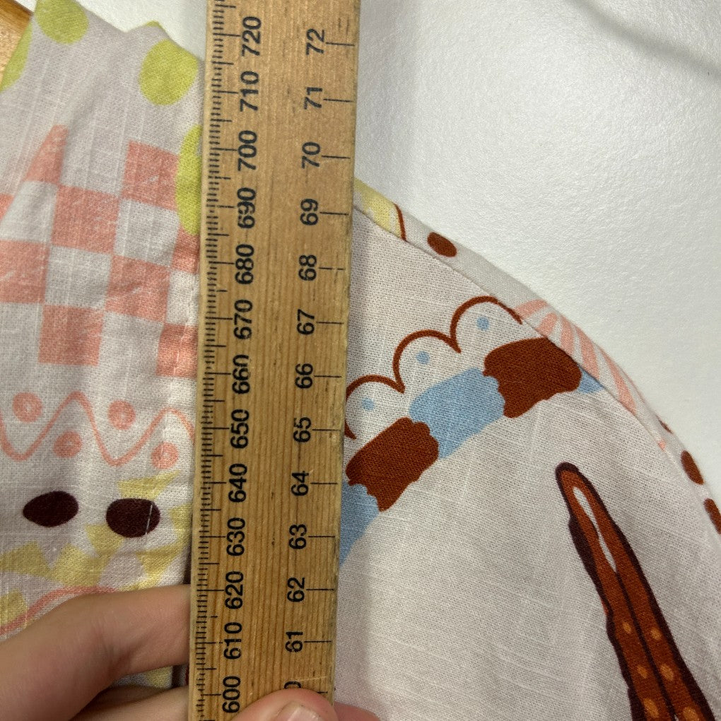 Cream fabric with brown and blue graphic print detail view