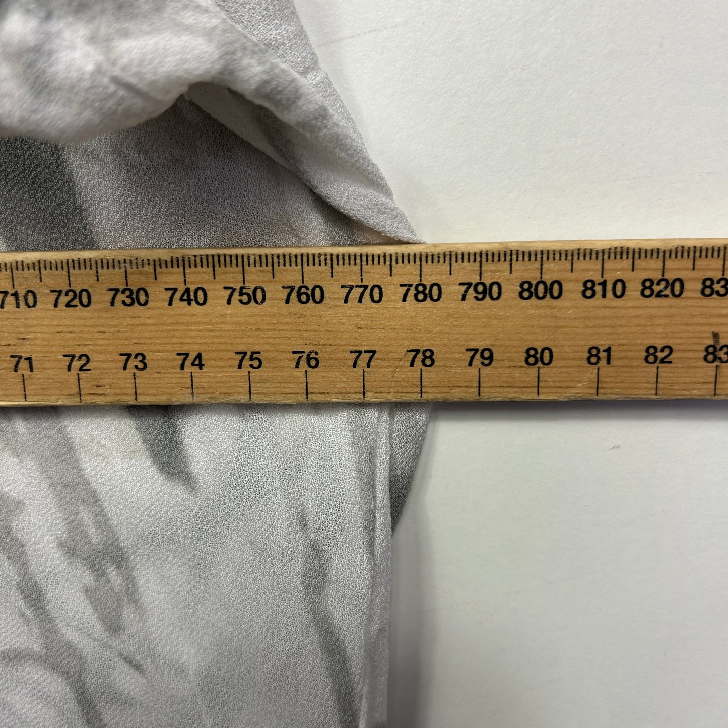 Grey fabric with measuring tape detail view