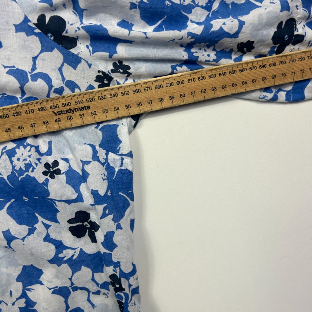 Blue and white floral fabric with measuring tape detail view