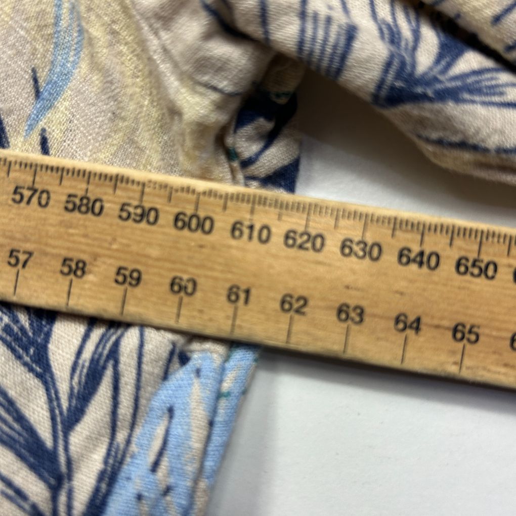 Blue and cream patterned fabric detail view with measuring ruler
