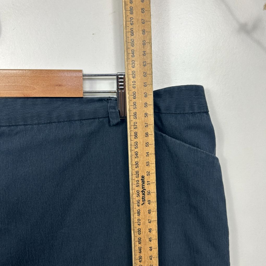 Dark blue jeans waistband detail with measuring tape