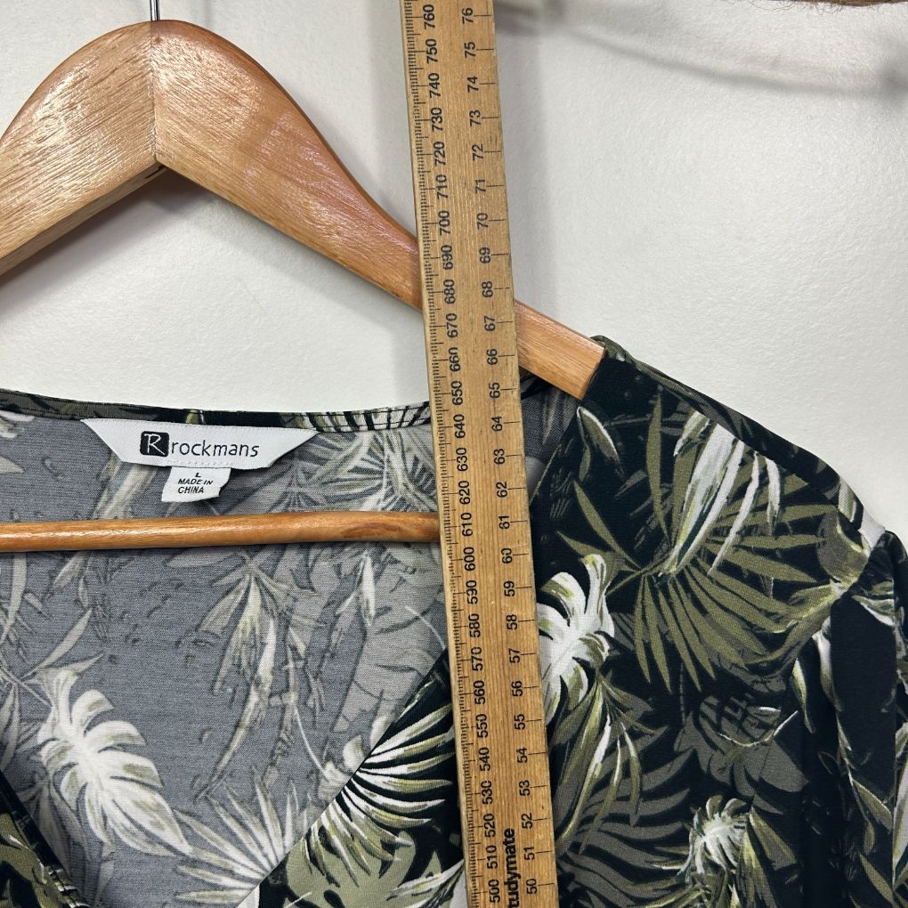 Black tropical floral shirt front view on hanger