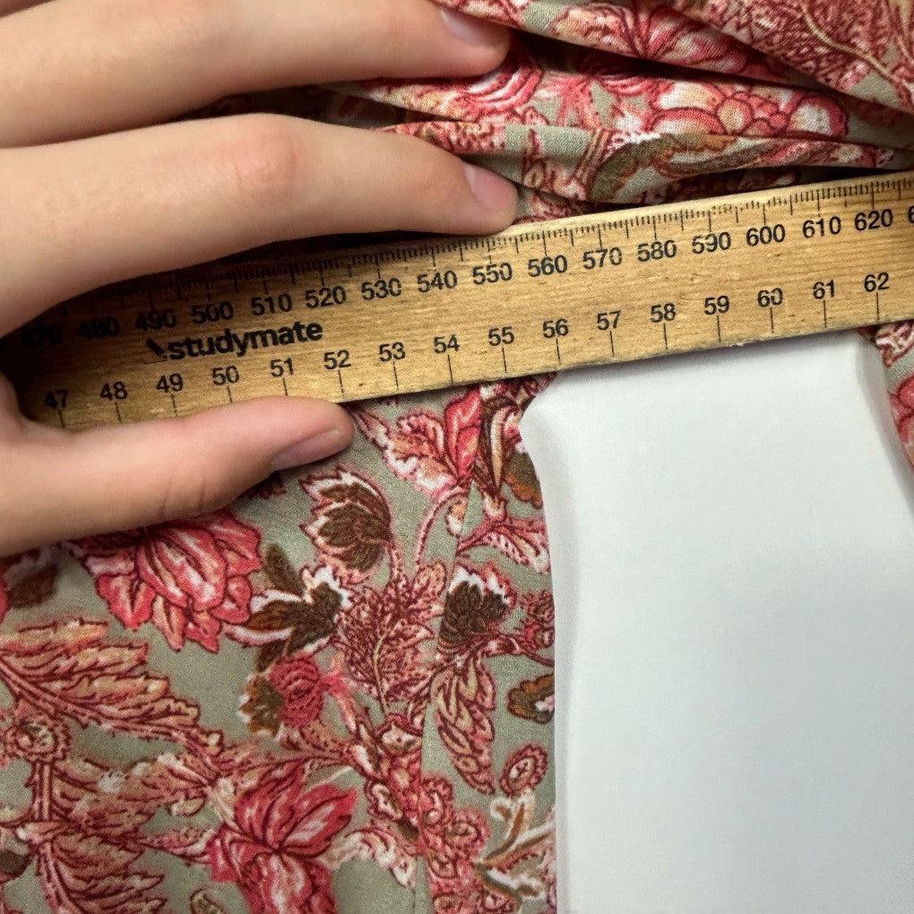 Red floral fabric detail view with measuring tape