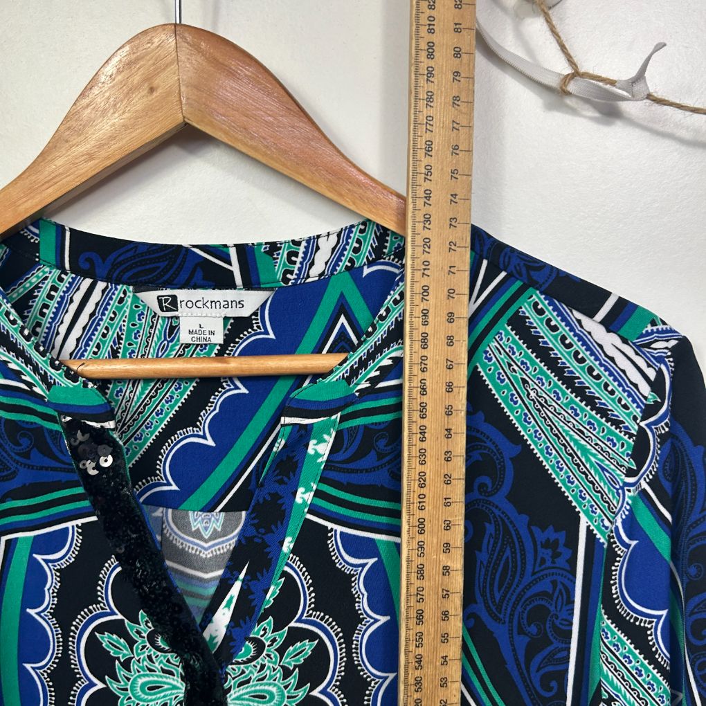 Navy blue shirt front view with green and white graphic pattern