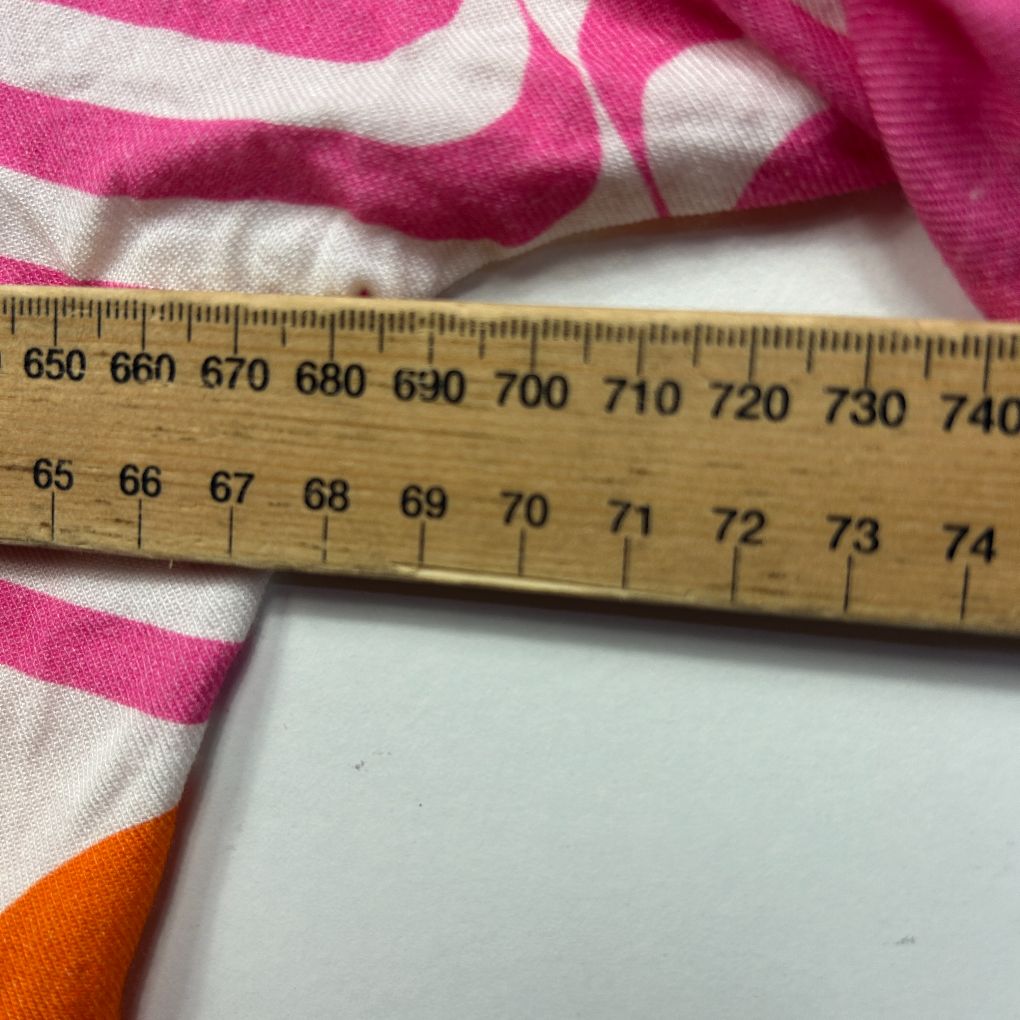 Pink and white striped fabric detail view with measuring ruler