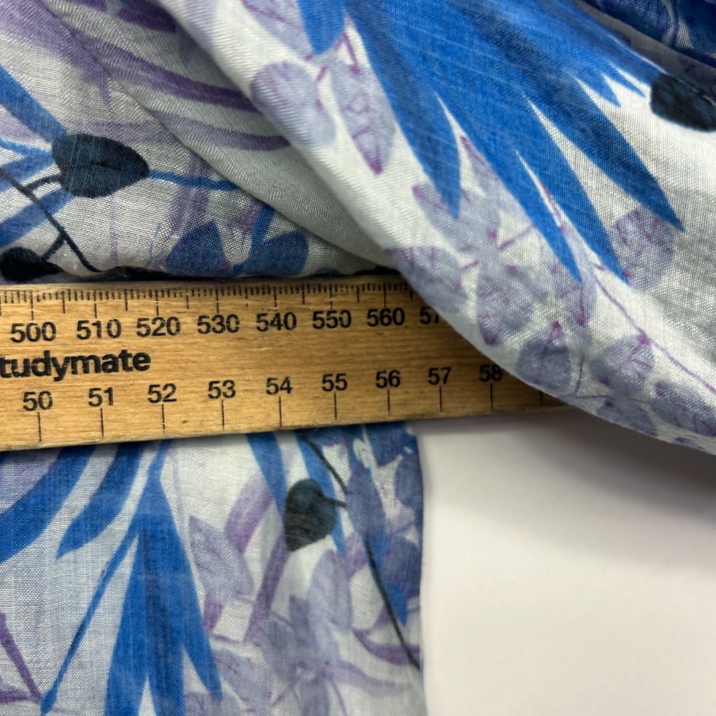 Blue and purple floral fabric detail view with measuring tape