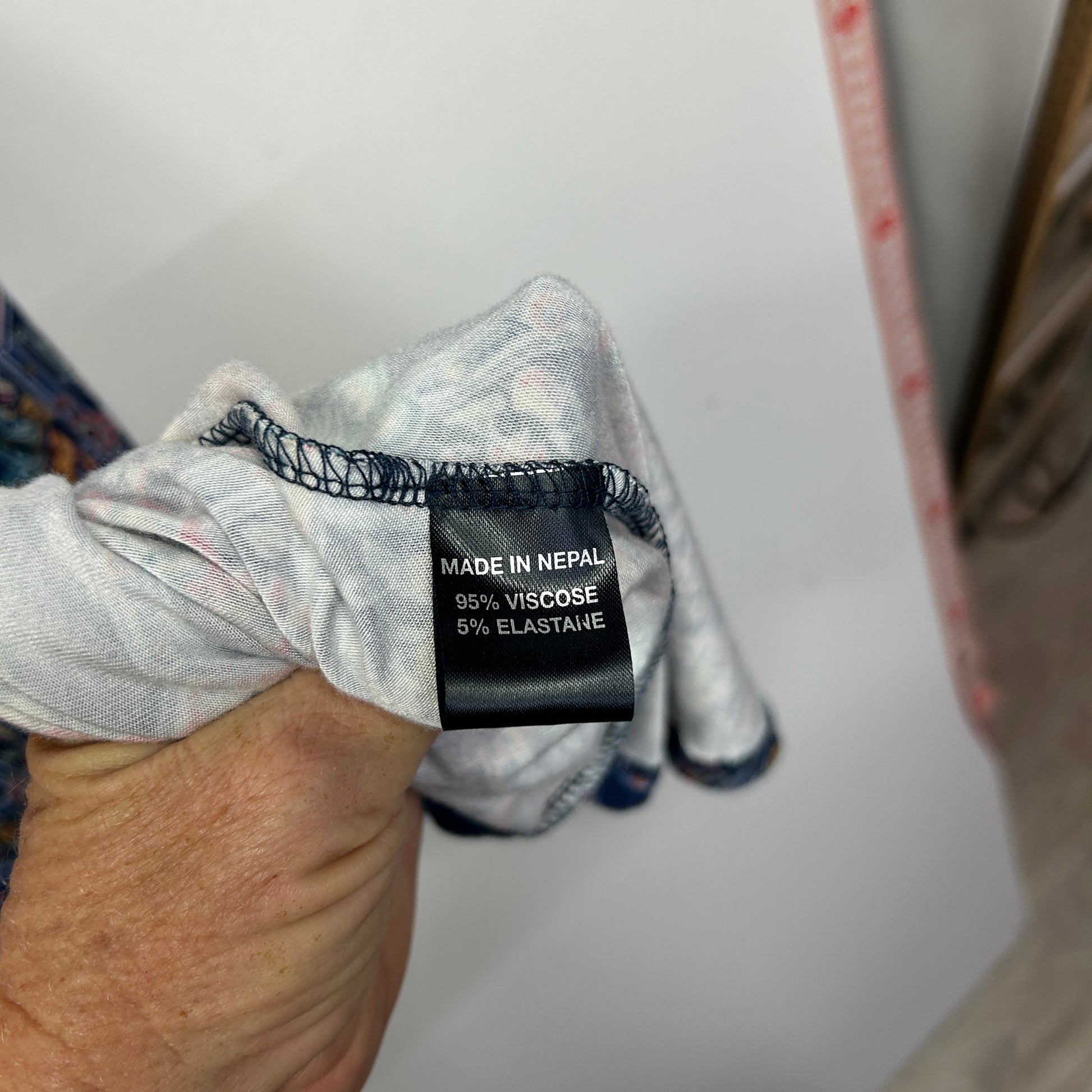 Grey long sleeve top label detail view