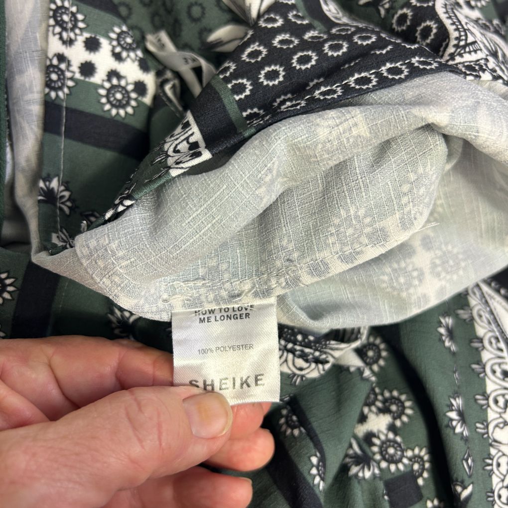 White and black patterned shirt detail view showing label