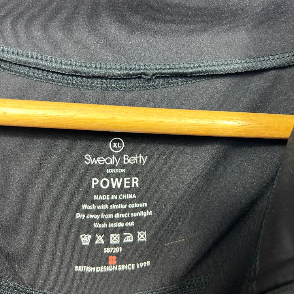 Black jacket label detail view showing Sweaty Betty Power branding