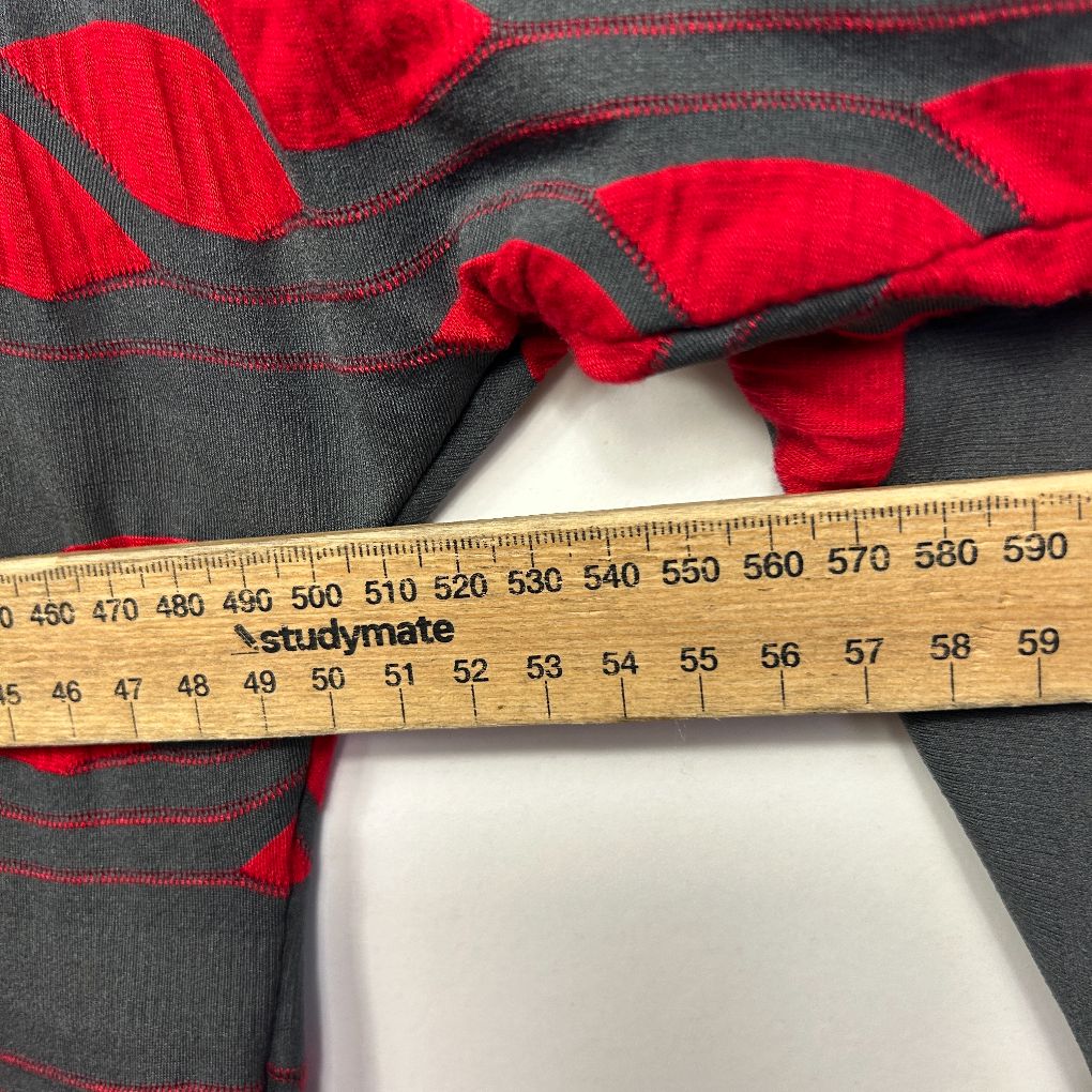 Red and grey striped jumper detail view with measuring tape