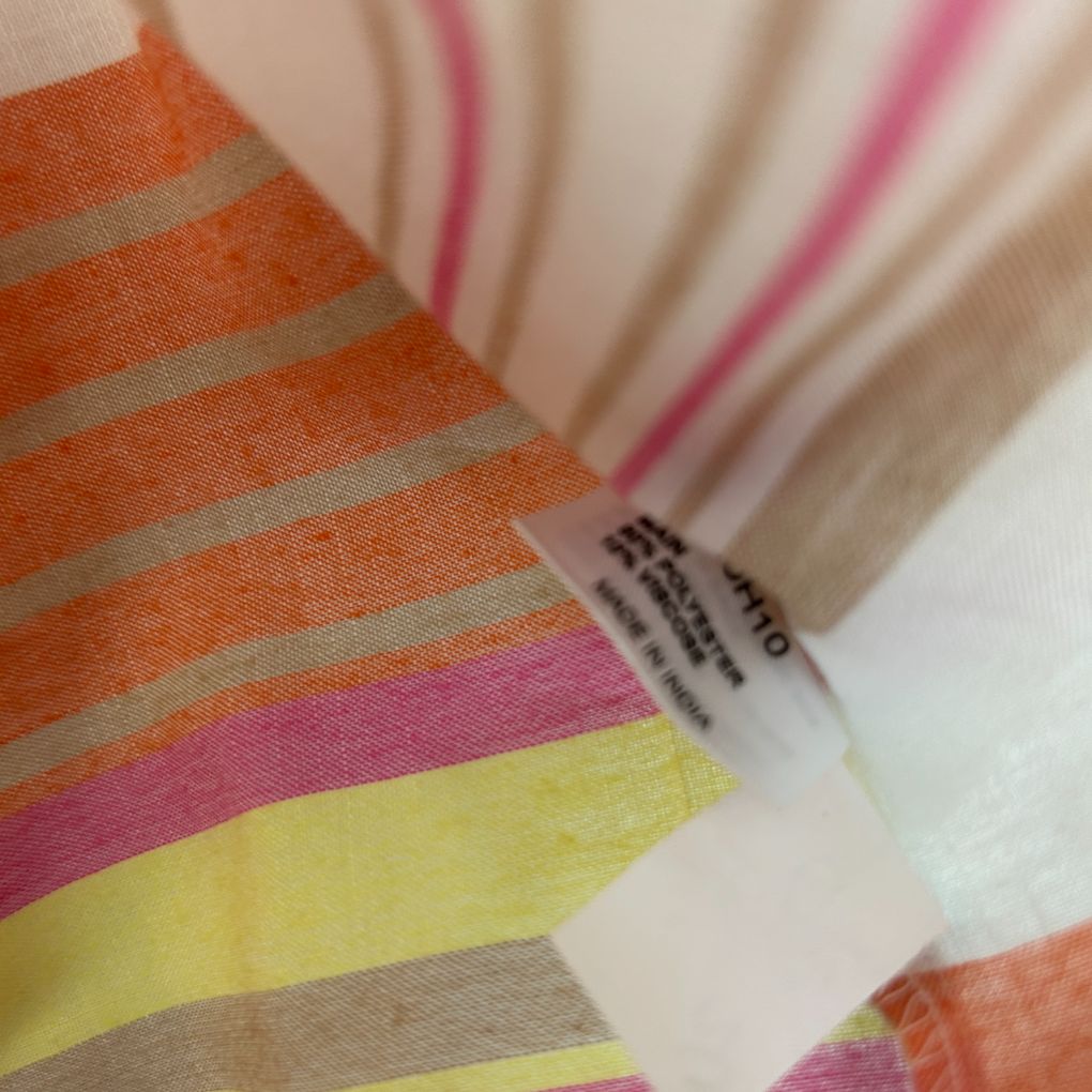 Striped scarf detail view with orange pink yellow and beige stripes