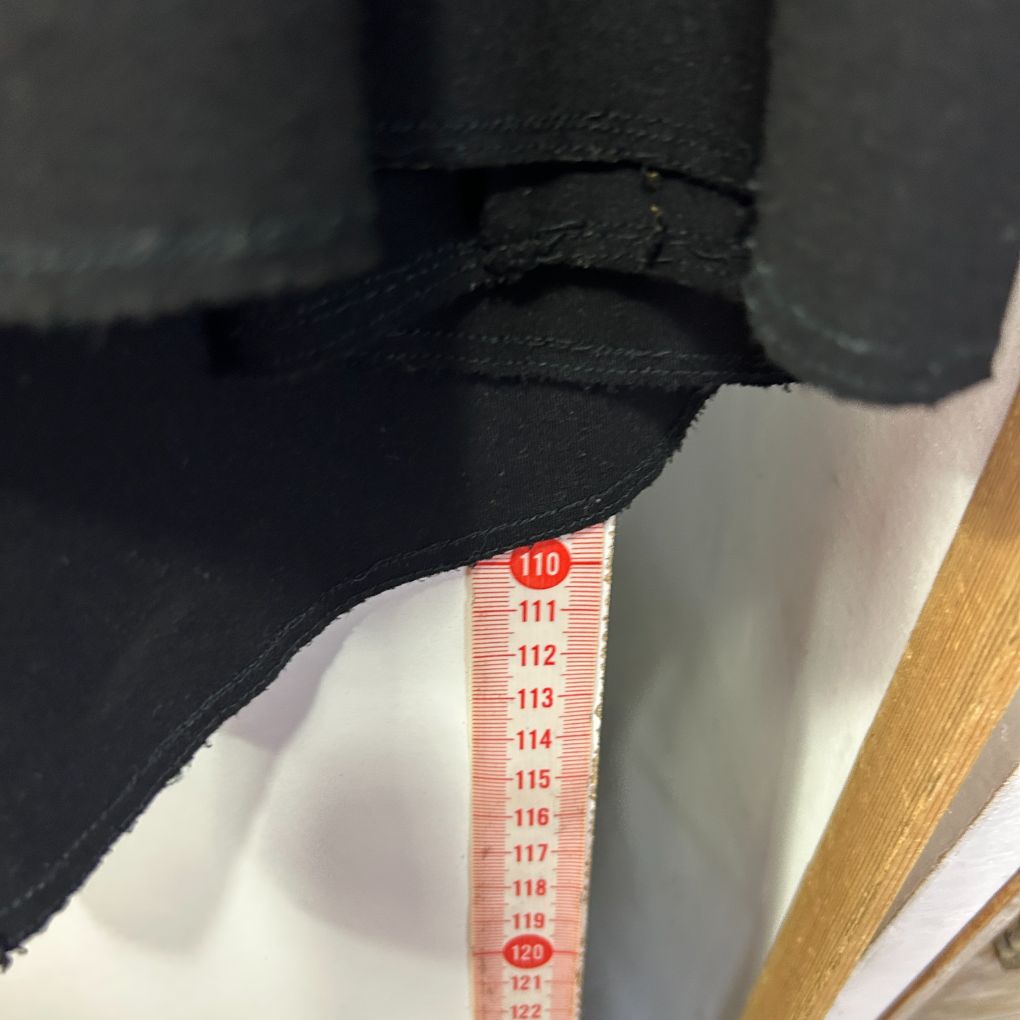 Black and white garment with measurement tape detail view