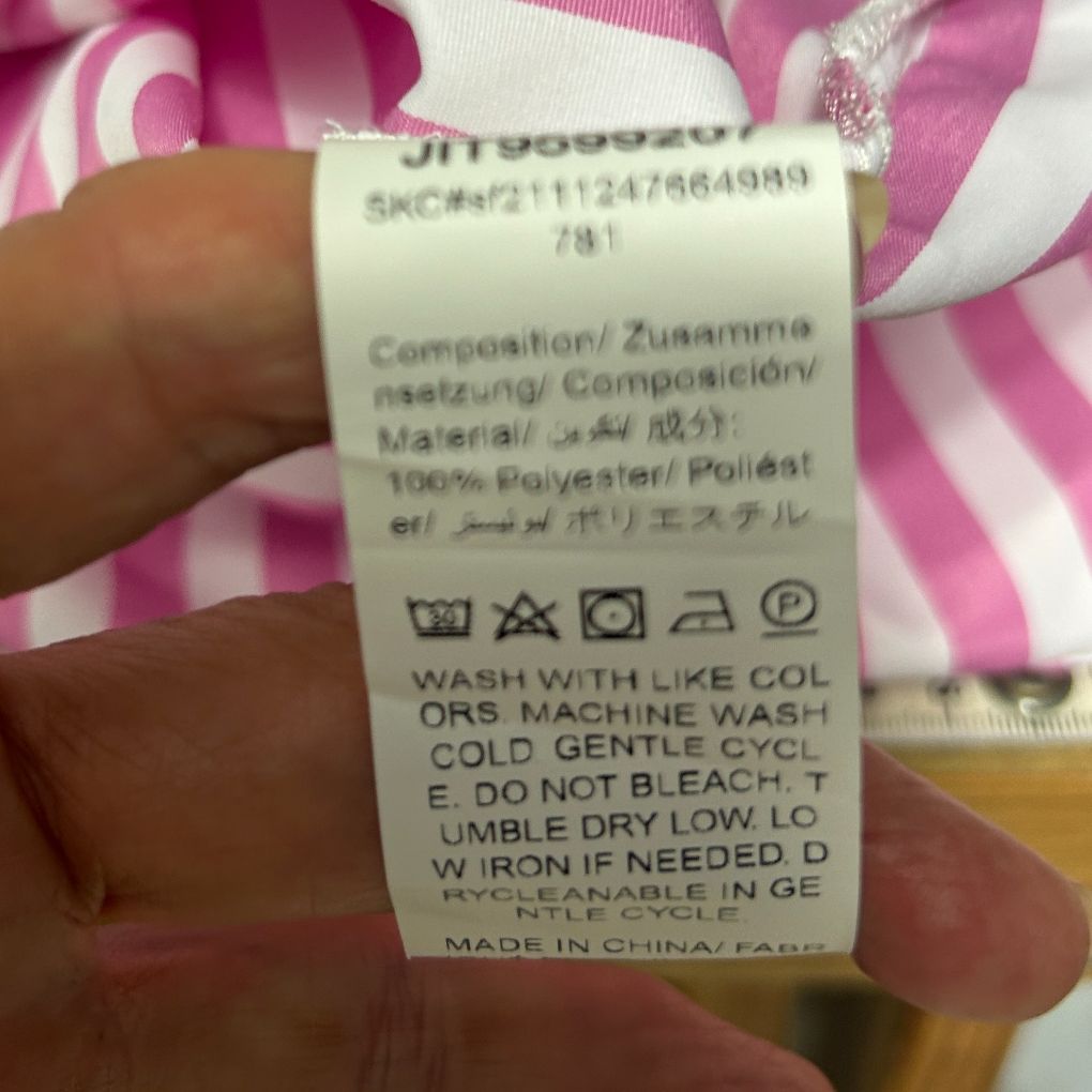 Pink and white striped clothing label detail view