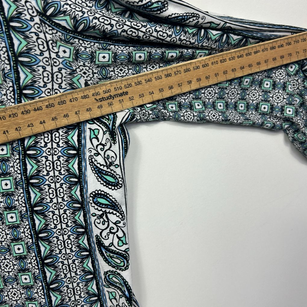 Navy and white patterned garment detail view with measuring tape