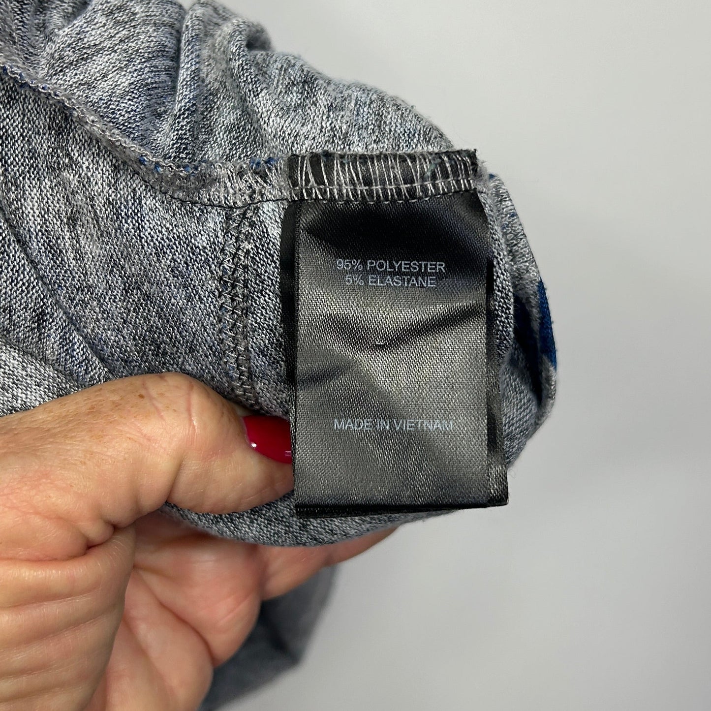 Grey and navy striped jumper label detail view