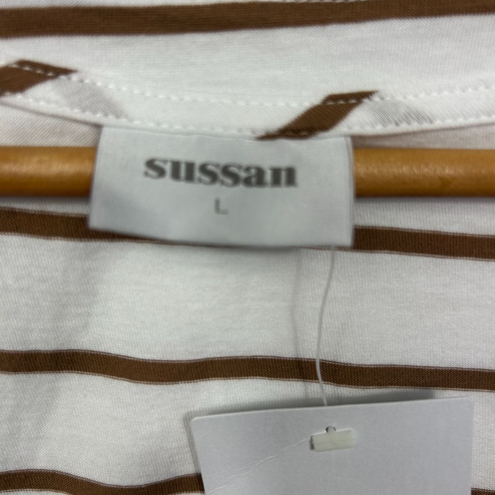 White and brown striped long sleeve top detail view