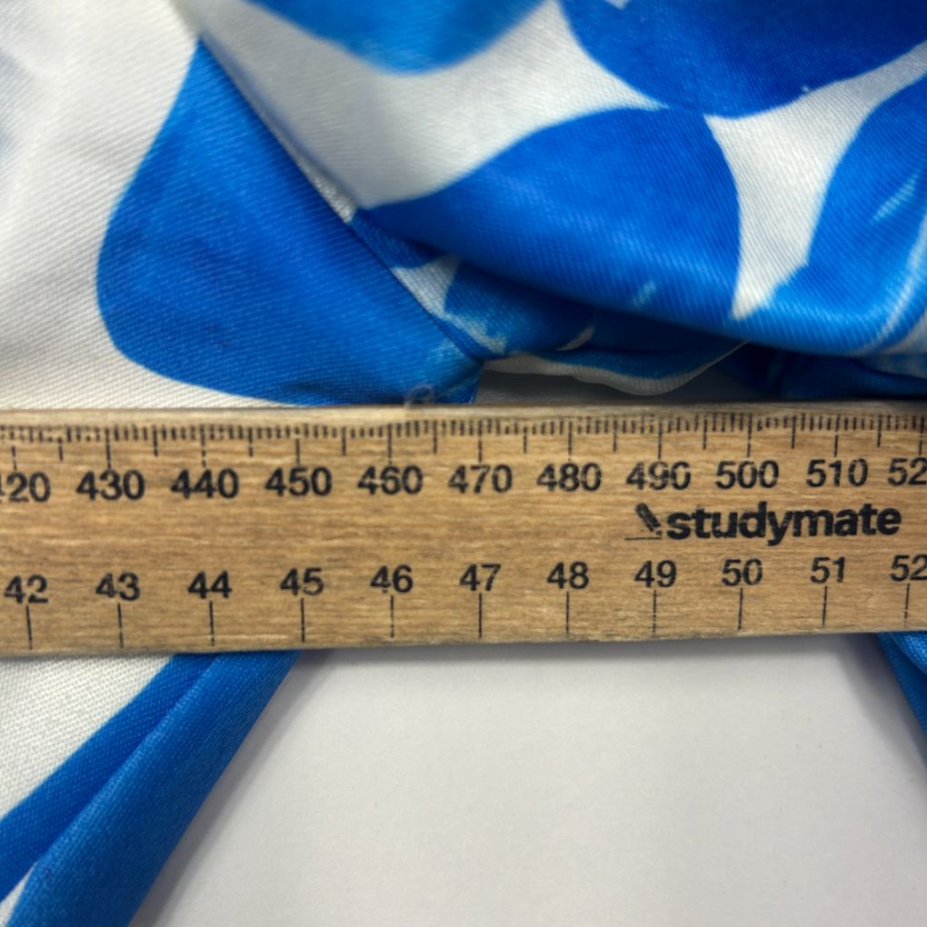 Blue and white striped ribbon detail view with measurement ruler