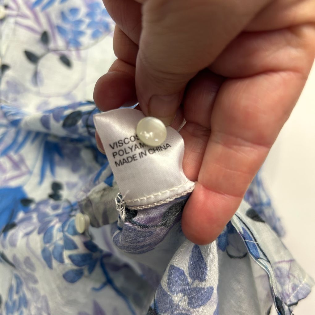 Blue and white floral dress label detail view