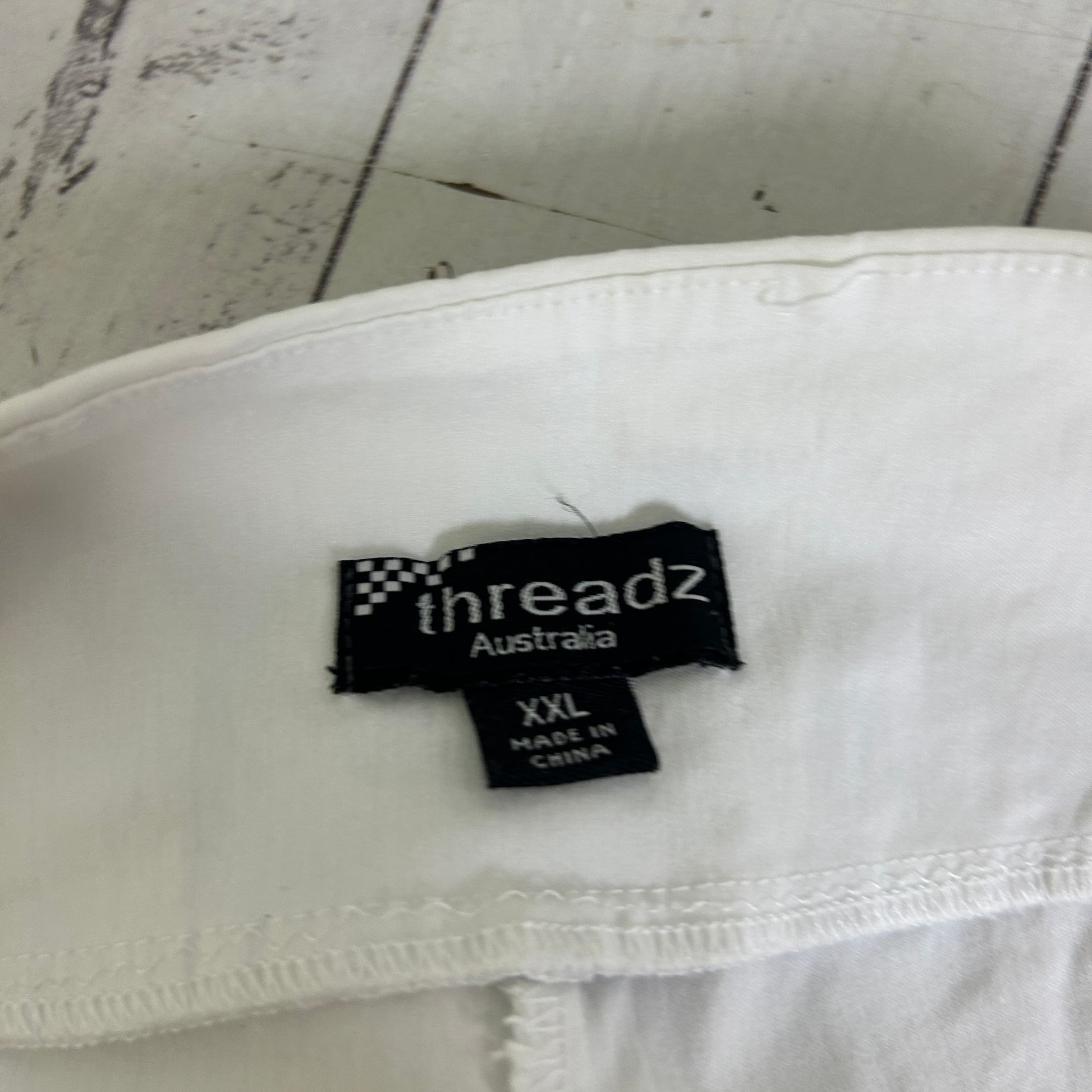White garment label detail view