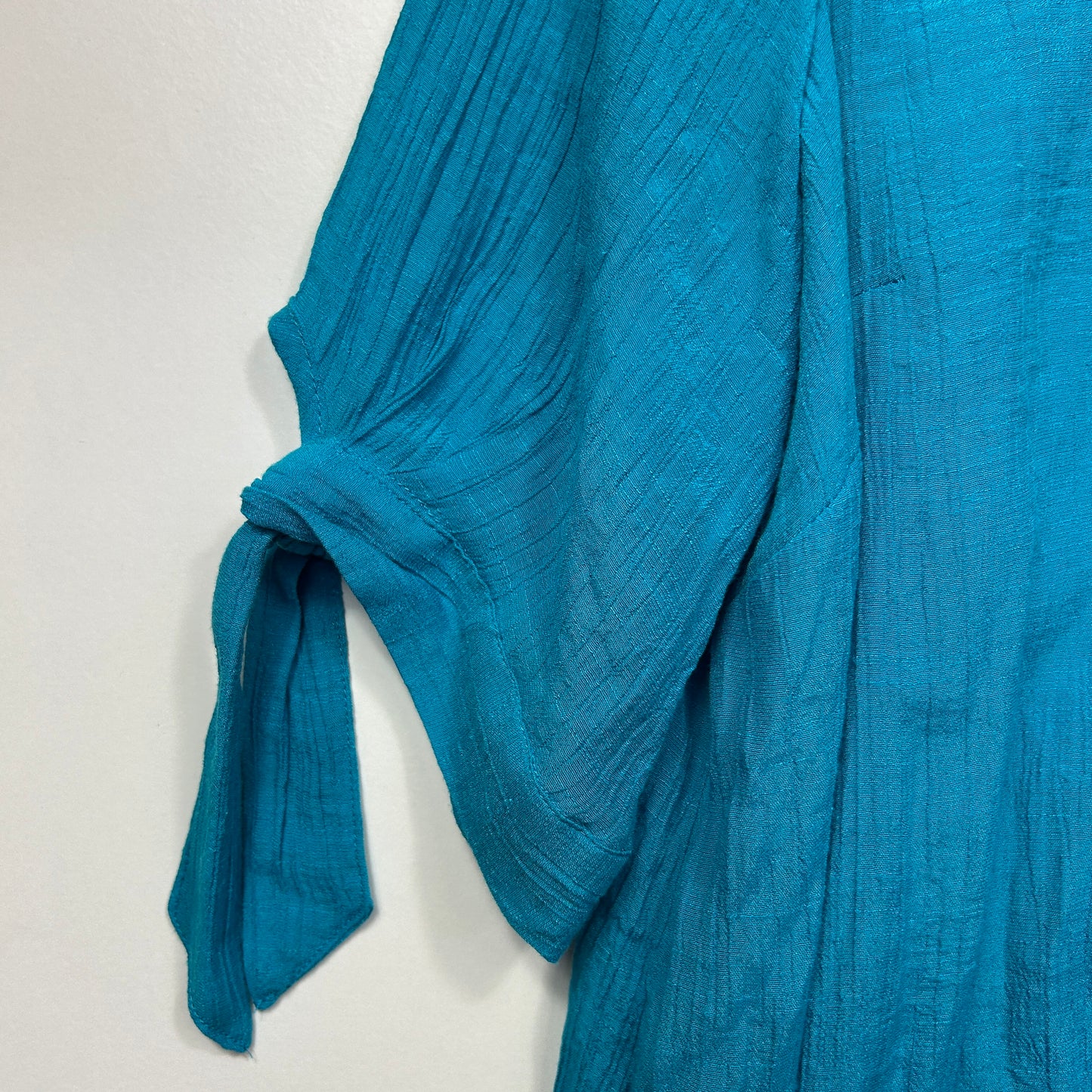 Blue textured blouse sleeve detail view