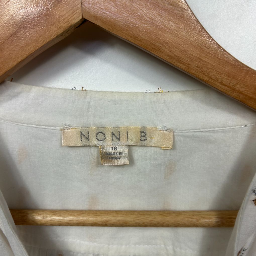 Cream blouse label detail view