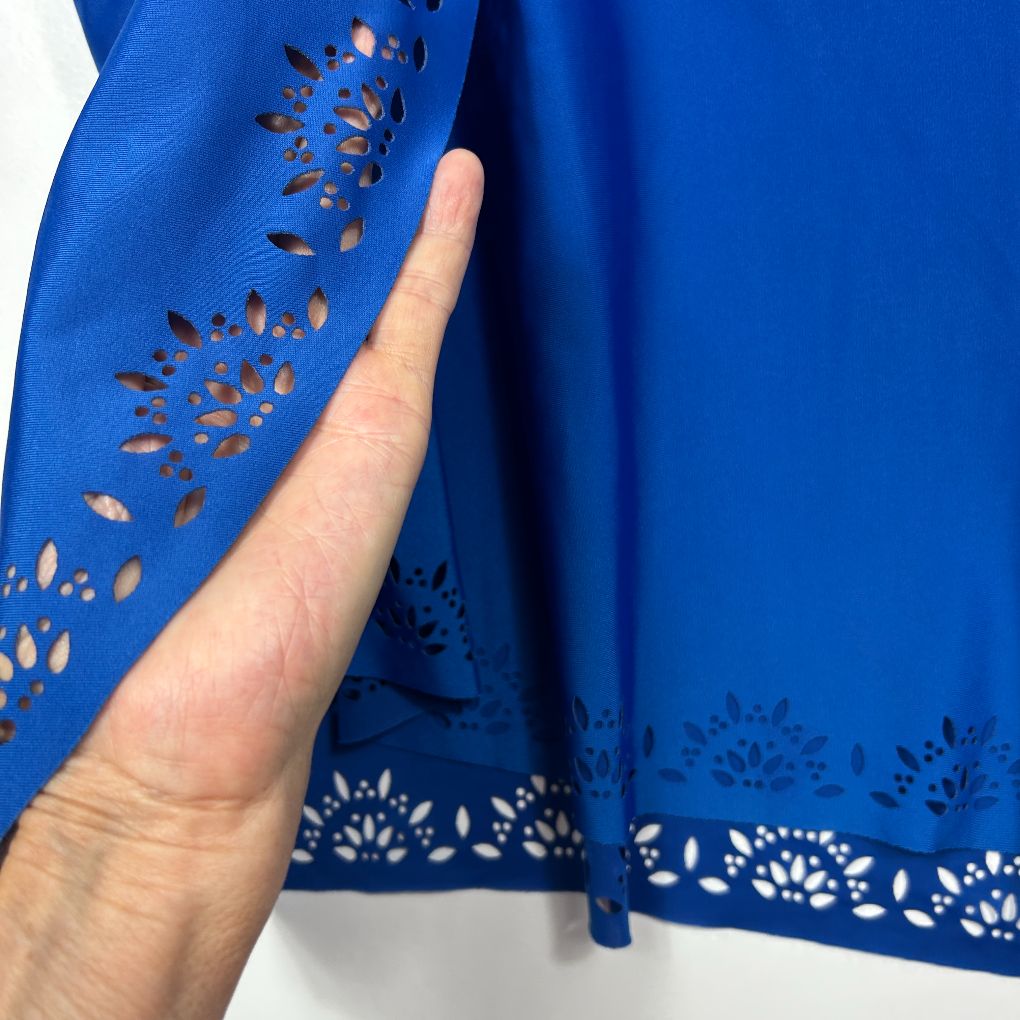 Blue dress detail view showing laser cut pattern