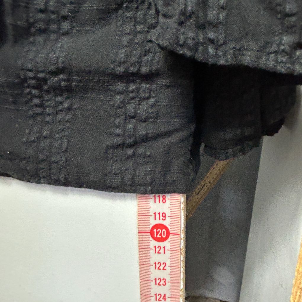 Black jacket detail view with measurement scale
