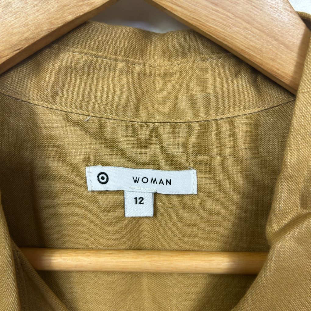 Gold shirt label detail showing size 12 woman