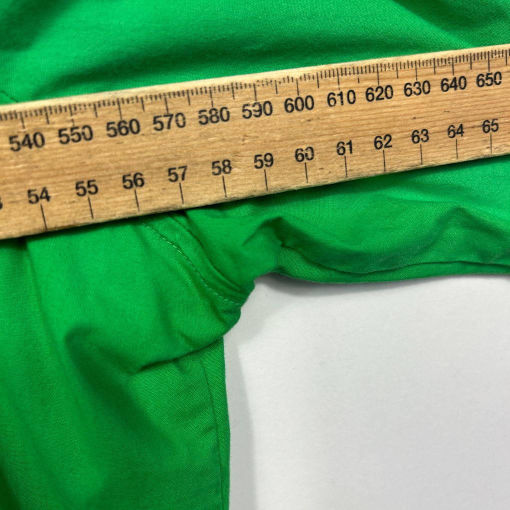 Green fabric with measuring tape detail view
