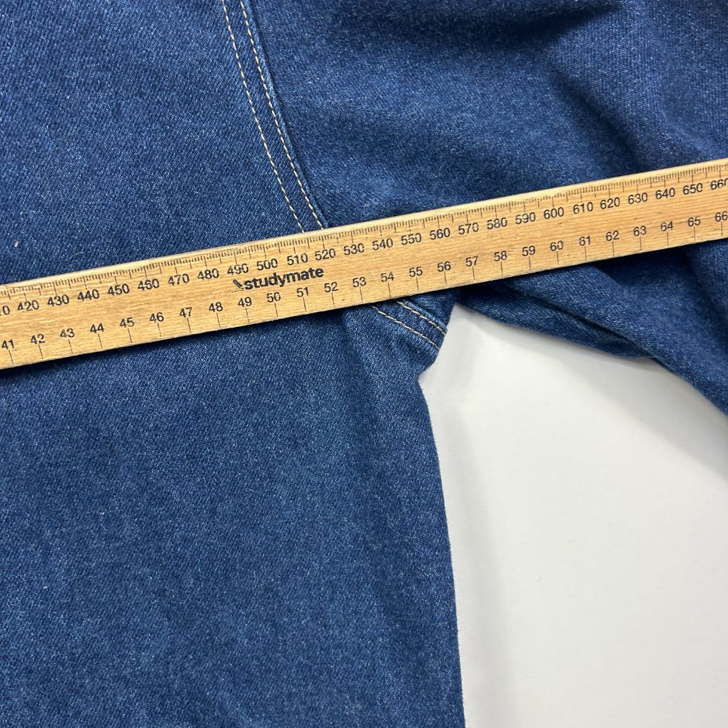 Blue denim garment detail view with measuring tape