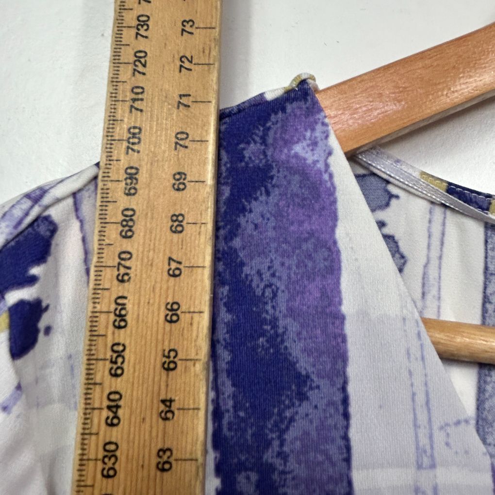 Purple and white patterned fabric detail view with measuring ruler