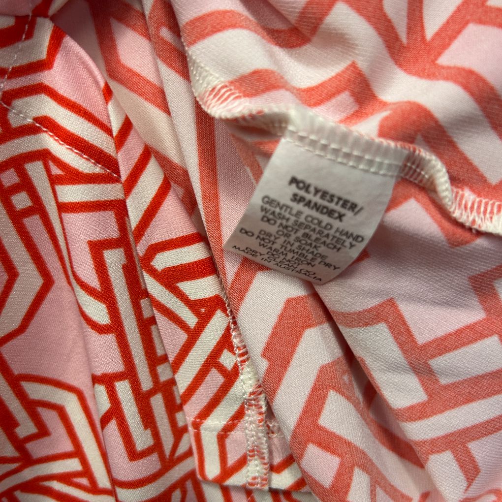 Red and white geometric patterned fabric detail view